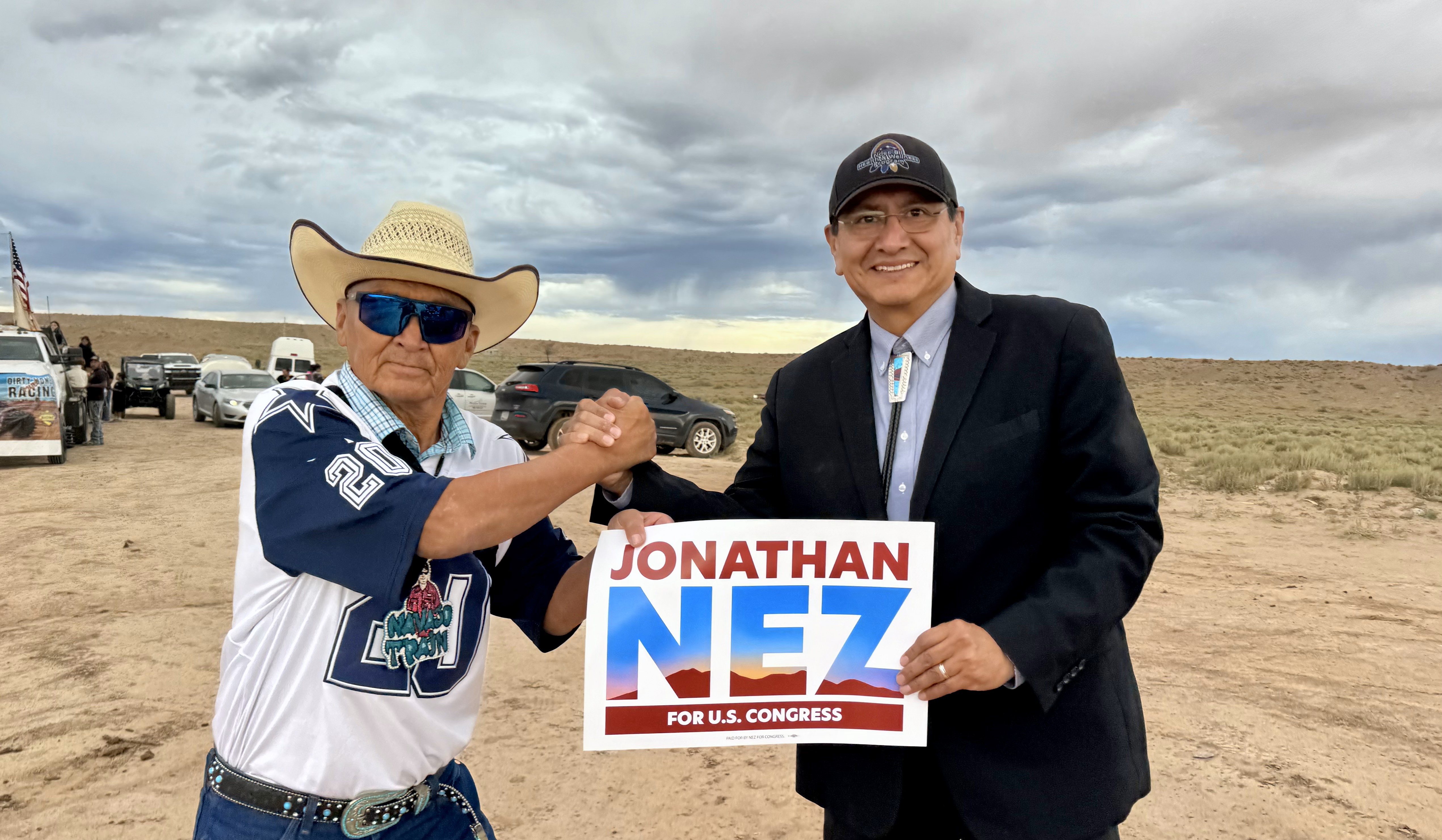 photo of Jonathan Nez greeting a supporter on a dirt road